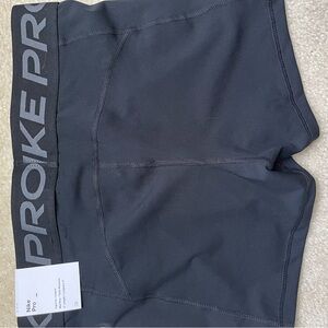 A pair of black nike pros. Size medium